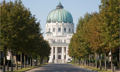 A church at the end of a tree-lined road in Vienna’s Central Cemetery